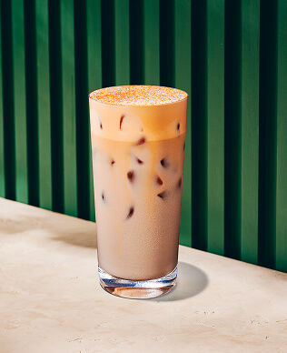 An iced pumpkin cream chai in a tall glass.