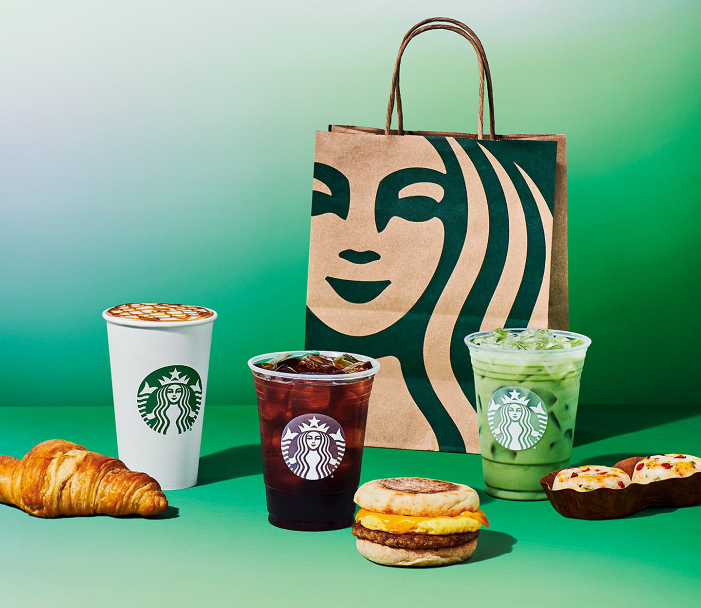Starbucks food and drinks with a Starbucks bag in the background